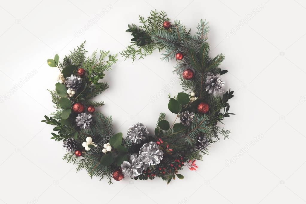 christmas wreath with balls, cones and mistletoe