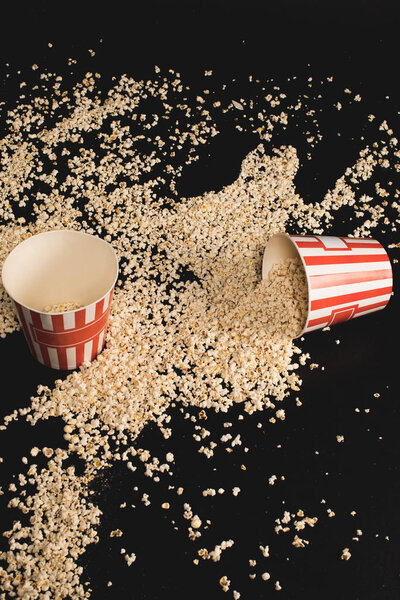 popcorn spilled of cardboard buckets