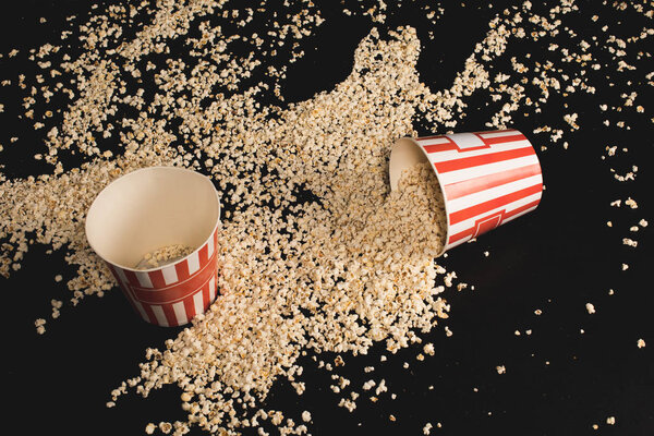 popcorn spilled of cardboard buckets