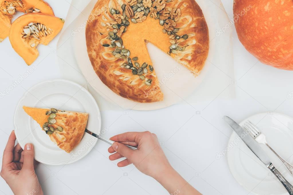 woman serving pumkin pie