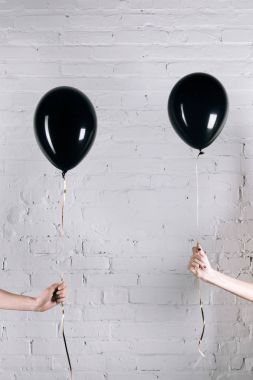 women holding black balloons clipart