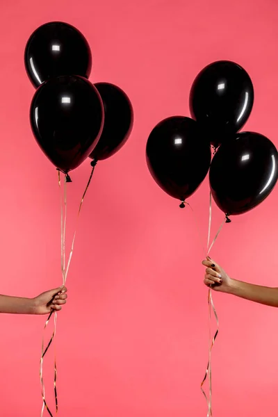 Black balloons in hands — Stock Photo, Image