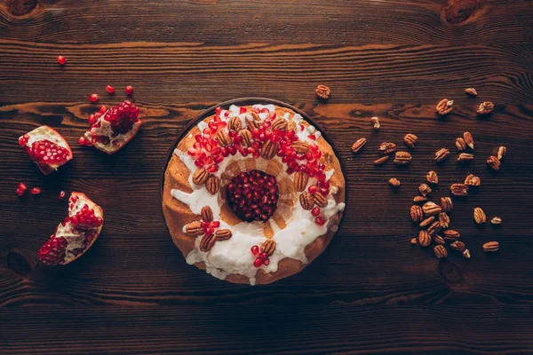 Christmas cake with pecan nuts and pomegranate — Stock Photo, Image