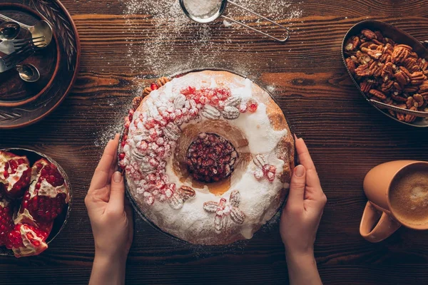 Hands with homemade christmas cake — Stock Photo, Image