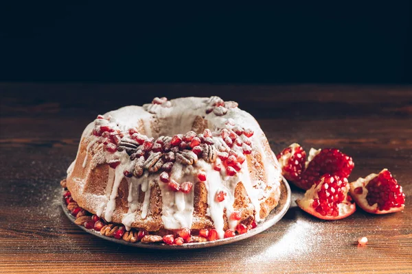 Christmas cake with pomegranate and icing — Stock Photo, Image