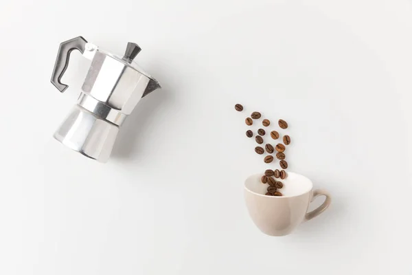 Coffee beans pouring into cup — Stock Photo, Image