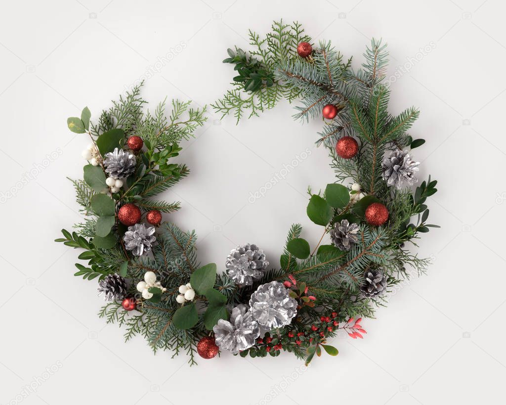 christmas wreath with balls, cones and mistletoe