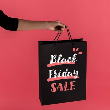 woman holding black shopping bag clipart