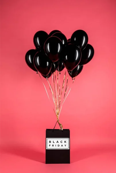 Black balloons and shopping bag — Stock Photo, Image