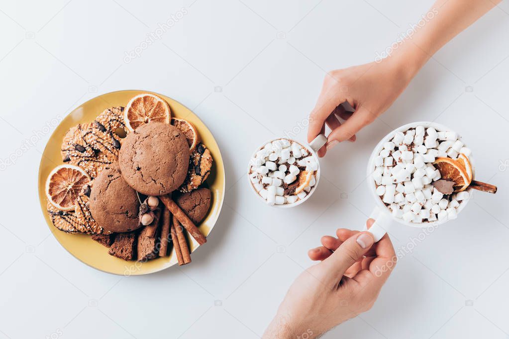 hands with cacao and cookies
