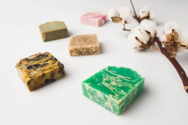 Various handcrafted soap with cotton branch — Stock Photo, Image