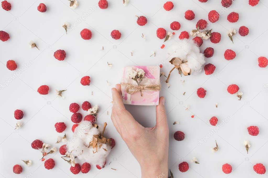 woman holding handcrafted berry soap