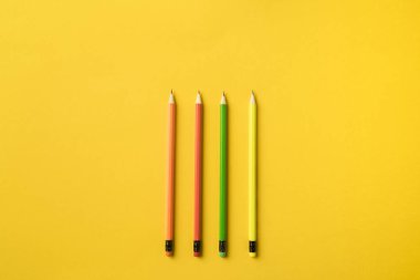 Four colored pencils with erasers clipart