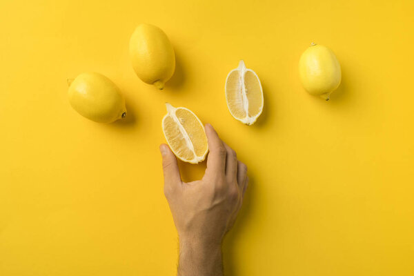 man holding half of lemon