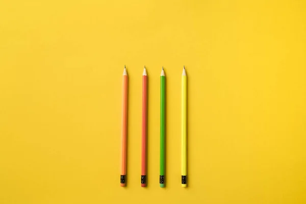 Four colored pencils with erasers — Stock Photo, Image