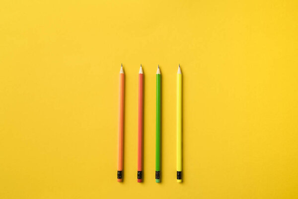 Four colored pencils with erasers