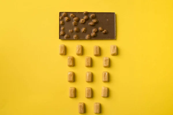 Chocolate bar and iris milk candies — Free Stock Photo