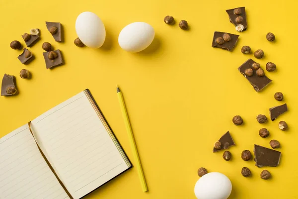 stock image Notebook and pencil with chocolate and eggs