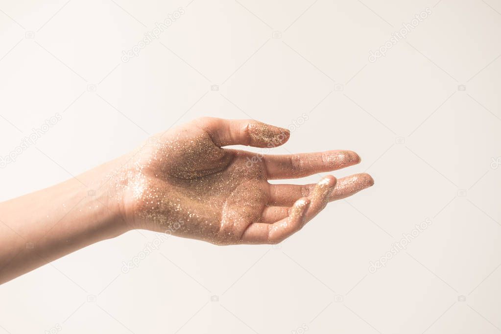 female hand in golden glitter