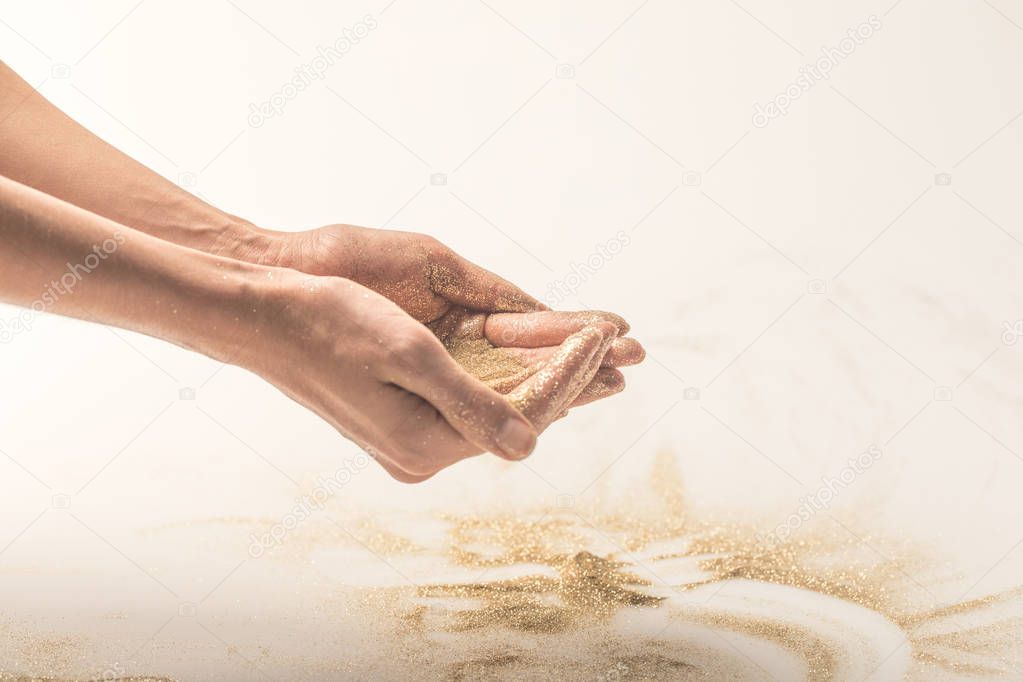 woman holding golden sequins in palms