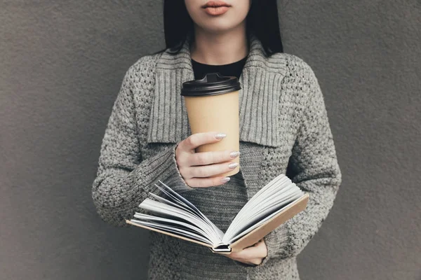 Mujer con libro y café para llevar —  Fotos de Stock