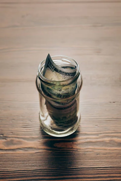 Glass jar with dollar banknotes — Stock Photo, Image