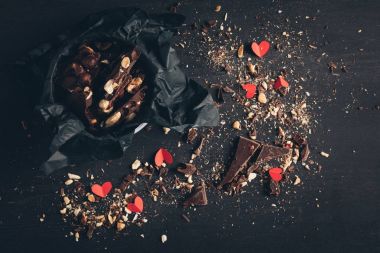 shredded chocolate and red paper hearts