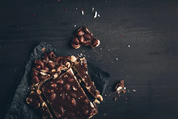 Dark chocolate with nuts pieces — Stock Photo, Image