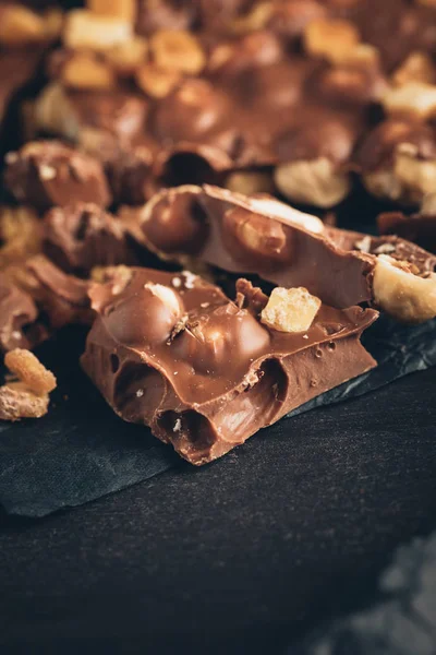 Milk chocolate with nuts pieces — Stock Photo, Image