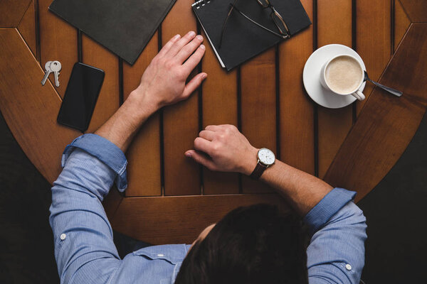 Man sitting at wooden table — Stock Image Man sitting at wooden table Royalty Free Stock Photos