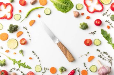 knife in circle of cut vegetables clipart