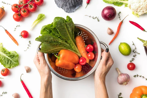 Woman holding colander with vegetables — Stock Image Woman holding colander with vegetables Stock Picture