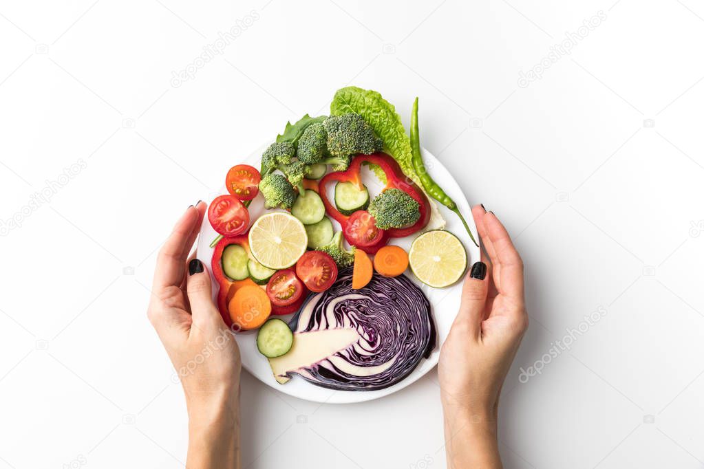 woman holding plate with salad