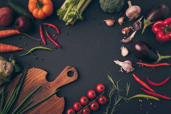 top view of different vegetables and cutting board on a table