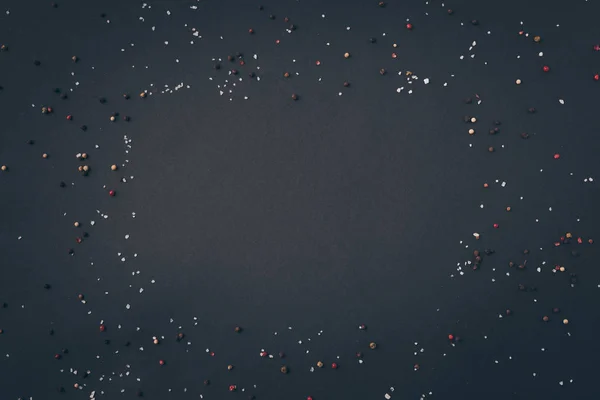top view of scattered pepper on gray table