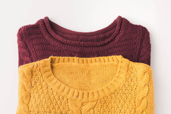 knitted burgundy and yellow sweaters
