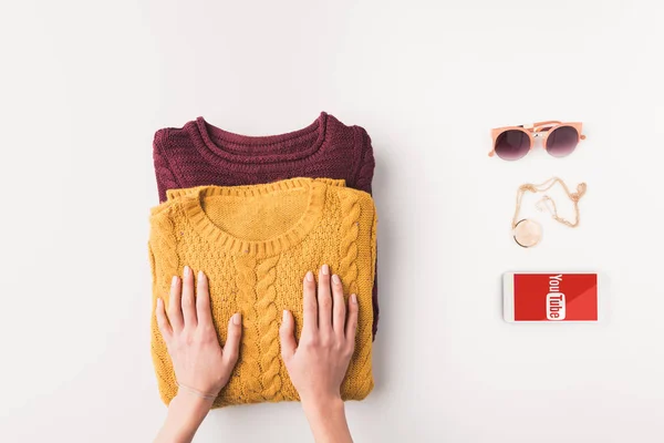 Sweaters and smartphone with youtube appliance — Stock Photo, Image