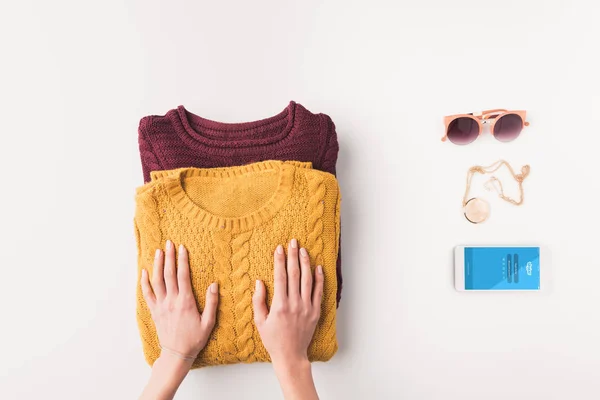 Sweaters and smartphone with skype — Stock Photo, Image