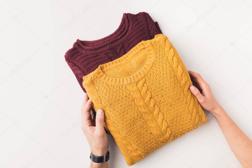 hands with knitted sweaters