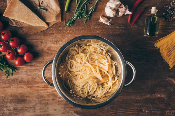 top view of spaghetti pasta and ingredients on wooden tabletop