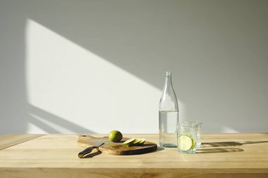 Limes kesme ve su ahşap masa üzerinde Detoks