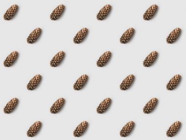 repetitive pattern of pine cones on white surface clipart