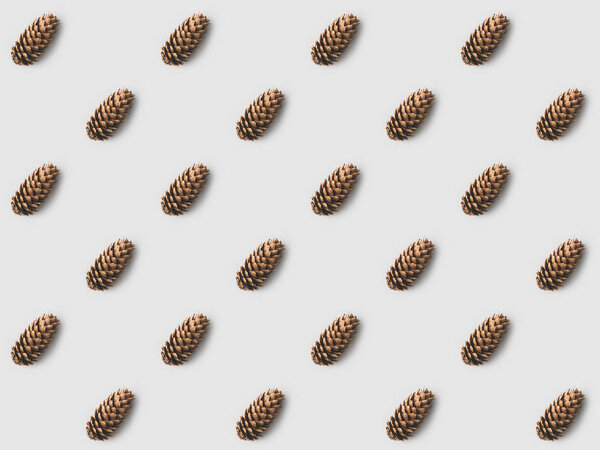 повторяющийся рисунок сосновых шишек на белой поверхности
