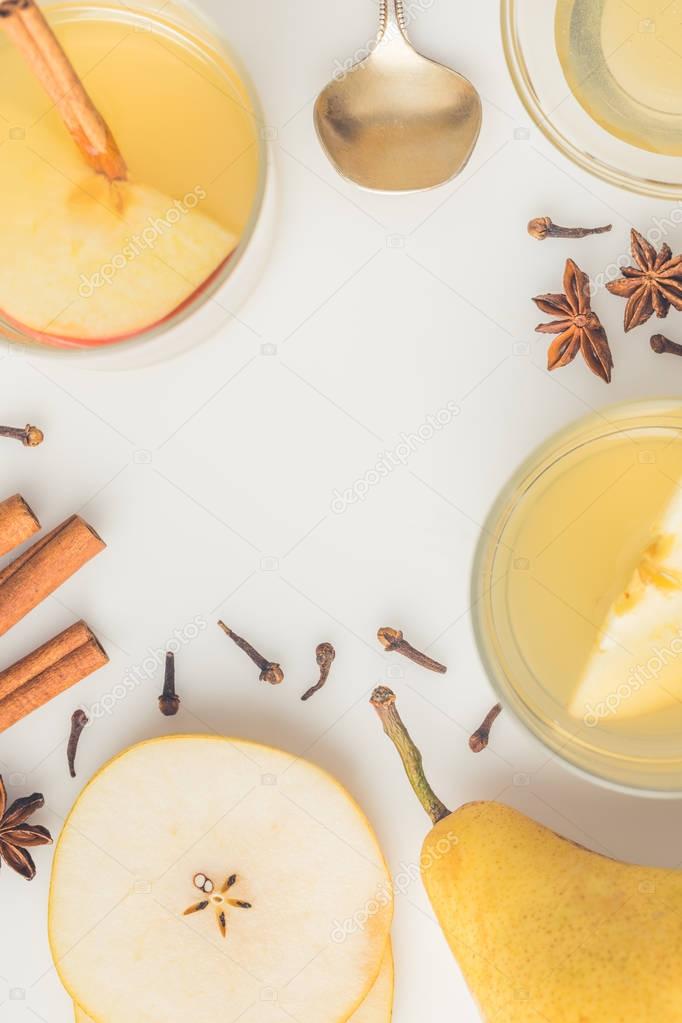 top view of delicious cider with spices on white surface