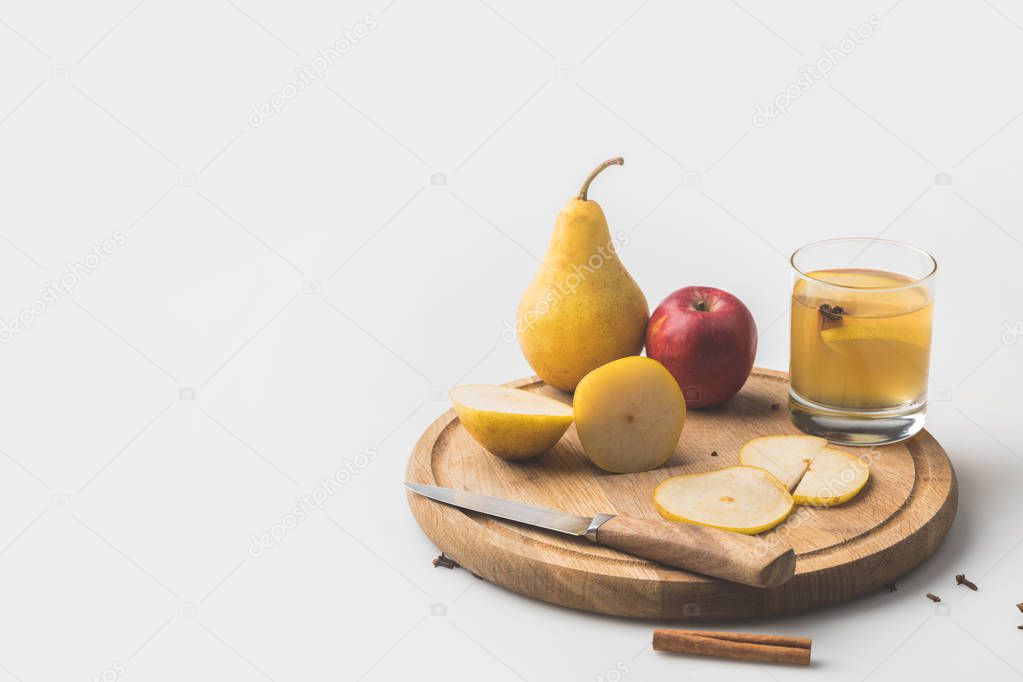 cider with apple and pear on wooden board on white