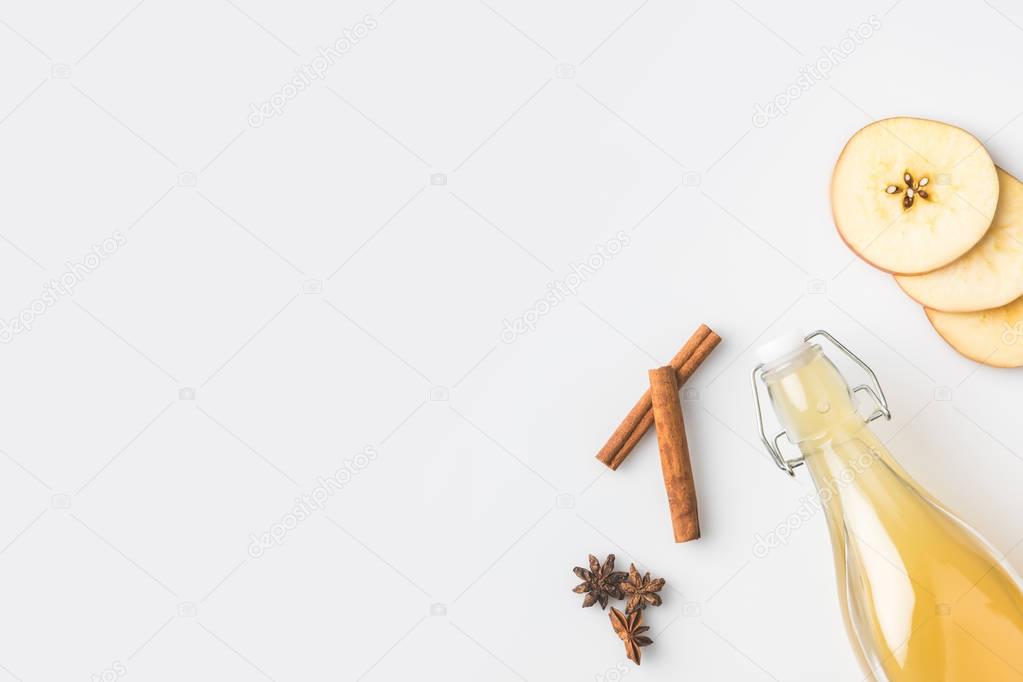 top view of apple cider composition with cinnamon sticks isolated on white