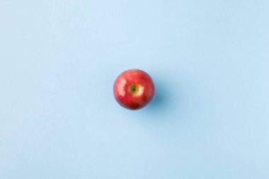top view of ripe apple isolated on blue clipart
