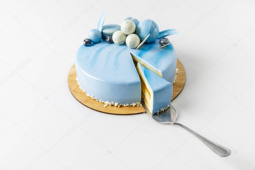 blue tasty cake on chopping board isolated on white