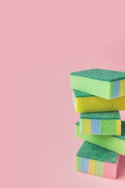 pile of colorful washing kitchen sponges, on pink clipart