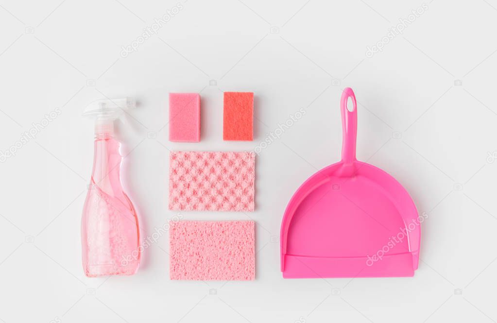 flat lay with pink washing sponges, bottle and scoop, isolated on white